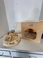 Wooden cube condo, plush bed insert, and separate faux-fur panel on countertop