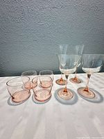 Group view of four tumblers and four stemmed glasses