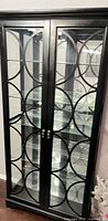 full view of black china cabinet with glass doors closed
