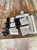 Group view of all cast iron fittings on wooden surface, most wrapped