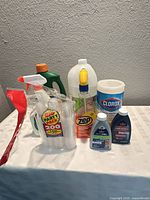Group of cleaning products and cups on table
