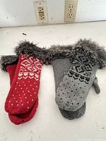 Gray and red mitten pairs side by side showing full designs and faux fur cuffs
