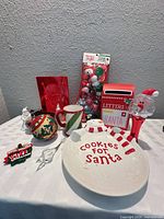 Full lot view: plate, mailbox, mug, ornaments, stocking stuffers pack, dispenser, gift bag