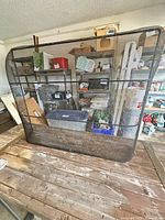 Front view of black mesh fireplace screen on table