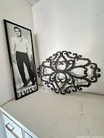 Elvis Presley framed poster standing beside metal plaque