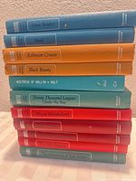 Front view of stacked hardcovers showing all 11 titles