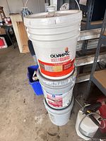 Stacked view of three 5-gal paint buckets showing labels