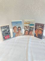 Group shot of four VHS tapes standing upright