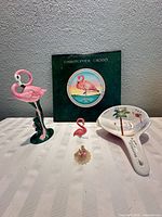 All four items together: LP, flamingo figurine, spoon rest, ornament