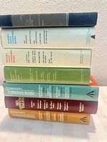 Stack of seven hardcover condensed anthology books showing colorful spines