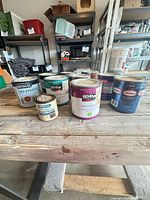 Overall view showing seven visible cans on workbench