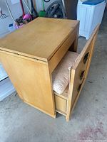 Cabinet side view with front door open showing cushion inside