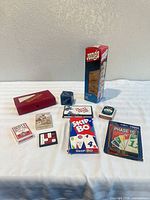 All items overview including Jenga box, dominoes case, card games, puzzles