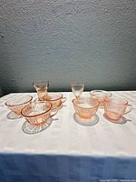 All eight pink glass pieces arranged on table
