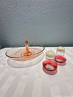 Handled serving tray and pair of shakers on table