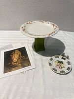 Group shot of cake stand, trinket dish, art print papers