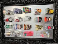 Full view of framed display showing all shot glasses