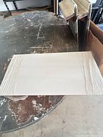 Top view of wrapped off-white tile on work surface