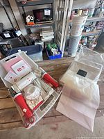 Entire emergency kit open in carry case beside stack of plastic bags