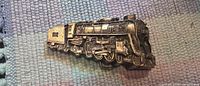 Front view of brass belt buckle showing full locomotive detail