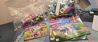 Bags of loose LEGO pieces plus three Friends instruction manuals for set numbers 41125 and 41013