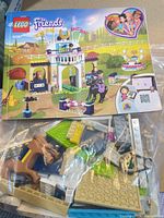 Instruction booklet and bag of loose LEGO pieces visible