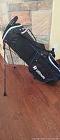 Side view of black Ultimate stand golf bag with legs extended