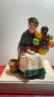 Front view of figurine with balloons and basket