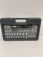 Closed case front view showing bits and sockets through lid