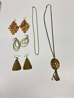 Overview showing all earrings and necklace laid out