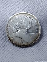 Reverse of 1944 Canadian 25 cent coin showing caribou and date