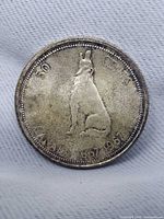 obverse or reverse view of 1967 Canadian 50 cent coin showing howling wolf design