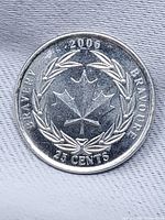 Reverse side showing maple leaf, laurel wreath, legends and date