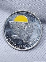 Reverse of 2011 Canada 25-cent coin with colourized sun and First Nations eagle design