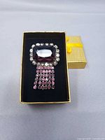 Front view showing amethyst glass, clear rhinestone border, purple fringe