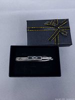 Tie clip displayed in open black gift box