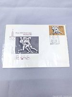 Front view showing one envelope with wrestling image, brown 4+2 kopeck stamp, Moscow 80 postmark, sealed in plastic