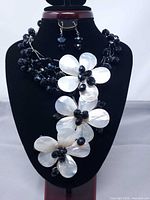 Full view of necklace on bust with matching earrings