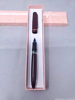 Full view of fountain pen with cap removed inside box