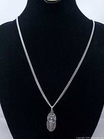 Full view of chain and pendant on display bust