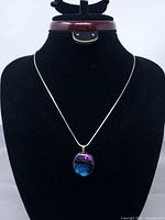 Full necklace on display bust showing chain and pendant