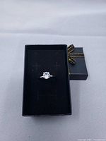 Ring in presentation box, top view showing solitaire stone and band