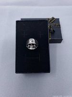 Front view of helmeted skull ring on display box
