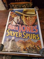 Full view of poster on table weighted at corners