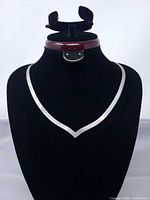 Full view of V-front sterling silver necklace on display bust