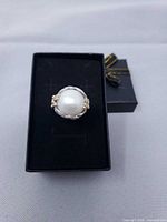 Full view of ring in presentation box showing pearl and band