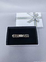 Tie clip in presentation box with lid visible