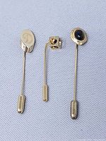 Front view of all three stick pins showing heads and clutches