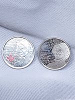 Both 2013 Laura Secord 25-cent coins, obverse side with designs visible