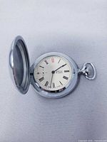 Open watch showing dial, hands, Adanac name, Roman numerals